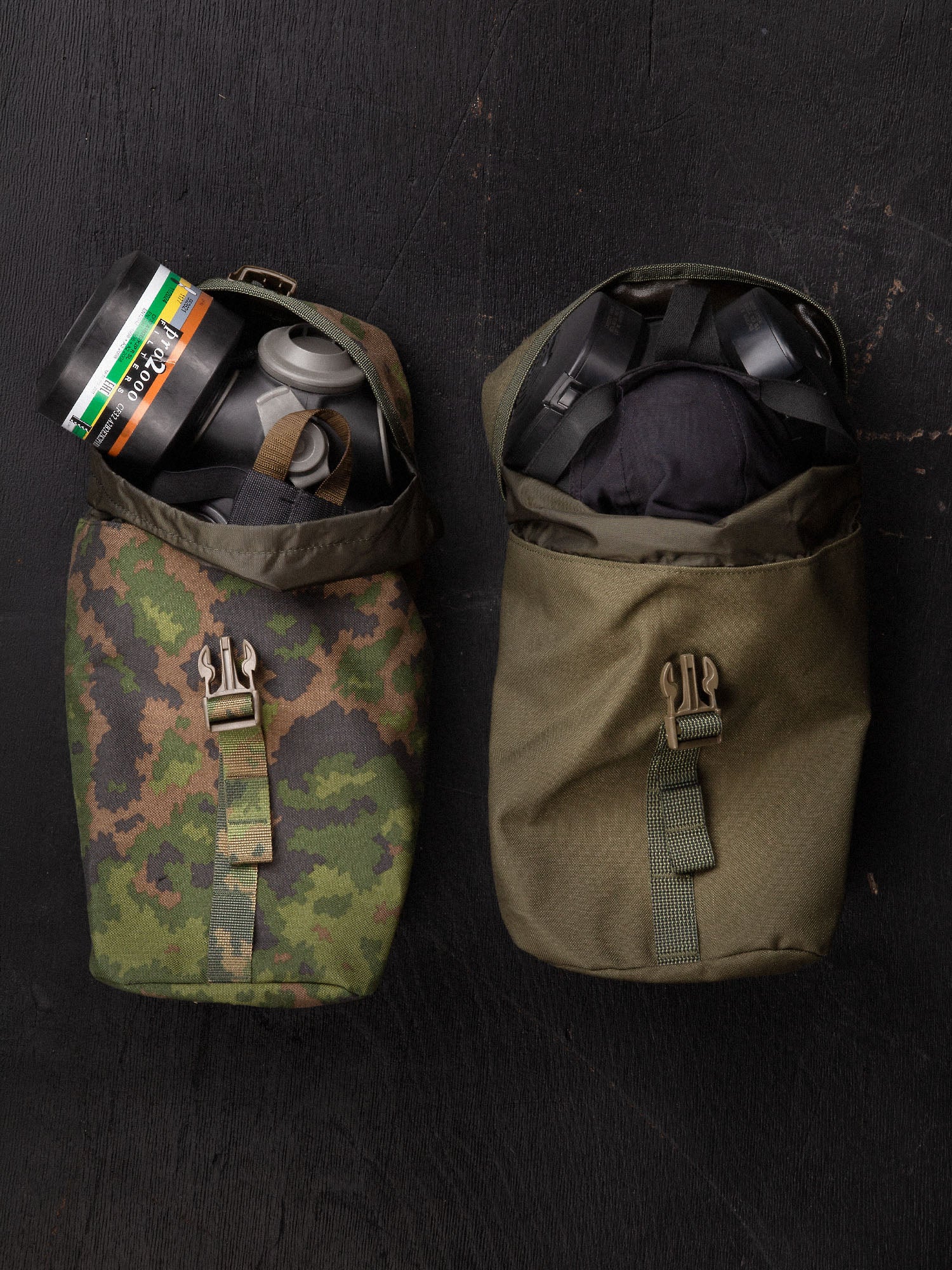 Two Savotta Lidded GP pouches 4x5 on a dark surface, both containing a gas mask.