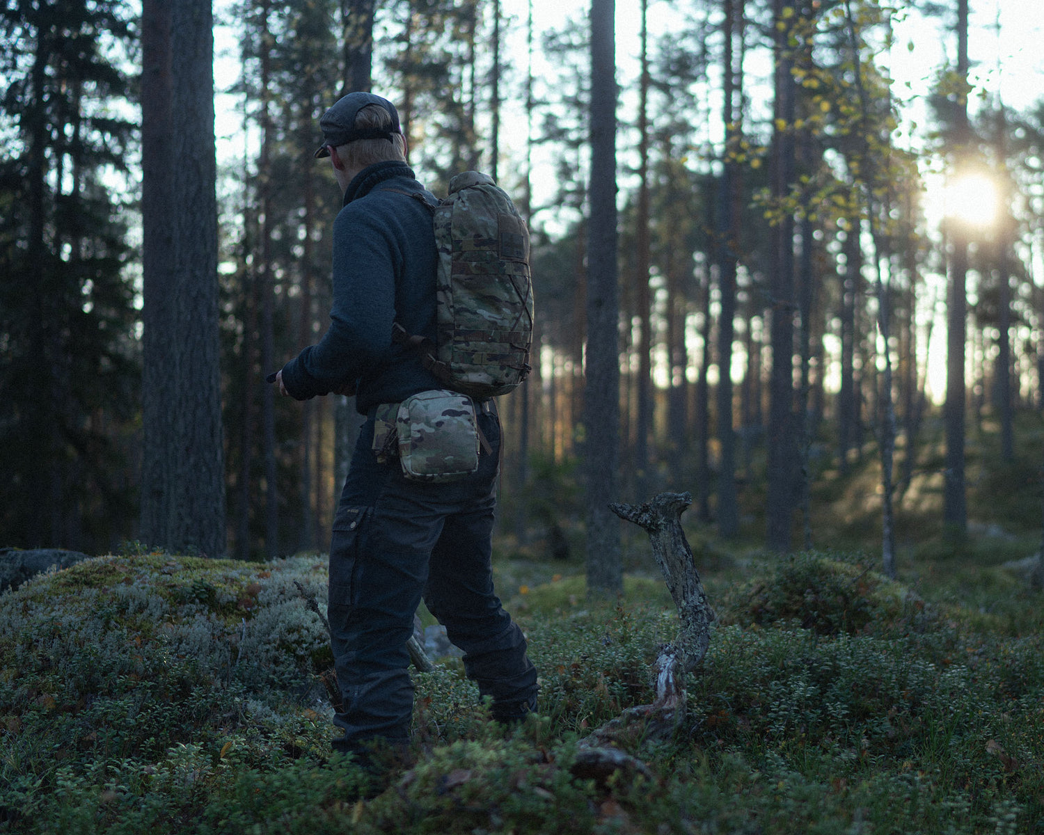 Person with a Savotta Hatka backpack walking through a forest