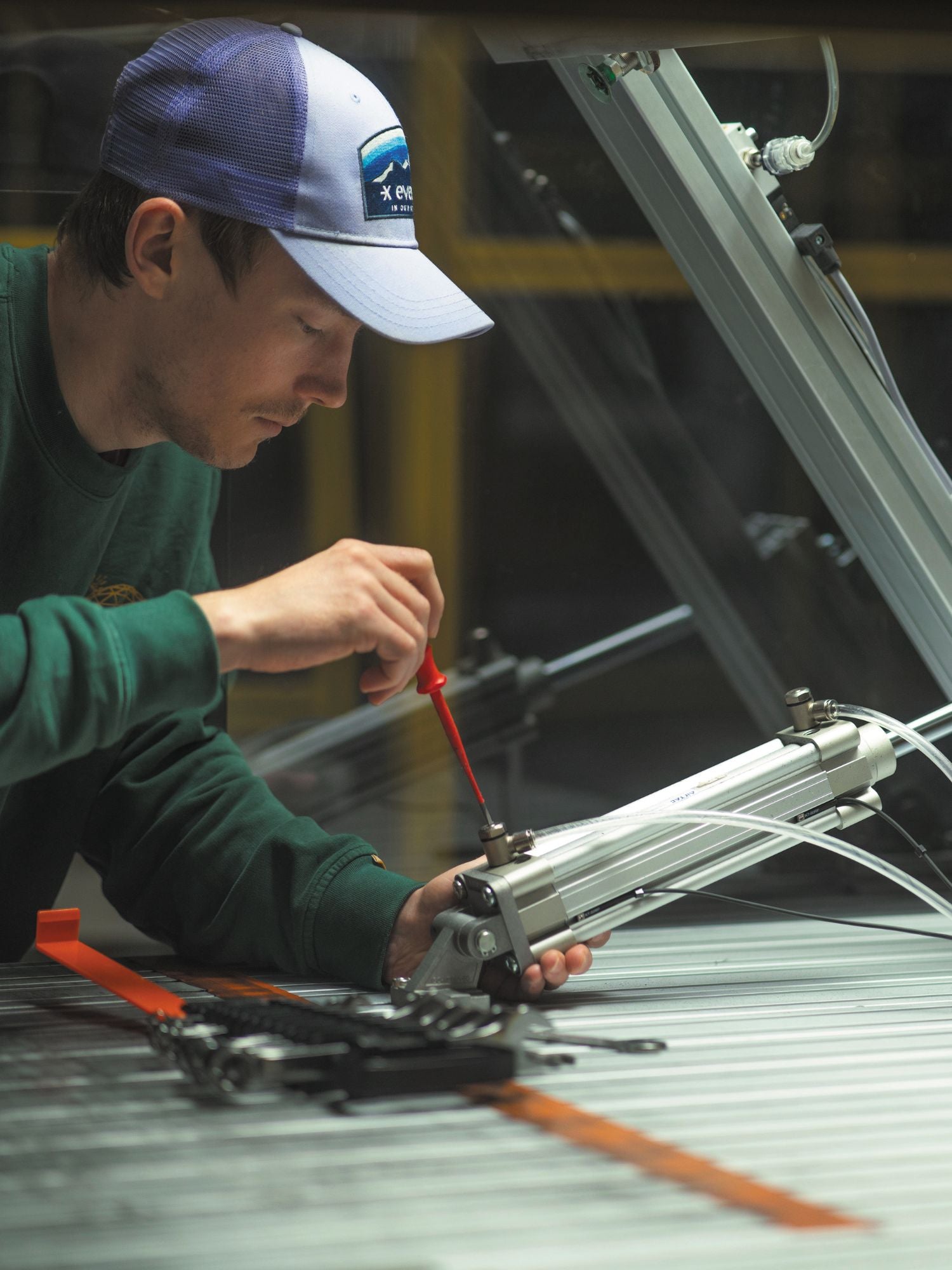 Person working on a technology mechanism at Savotta Systems.