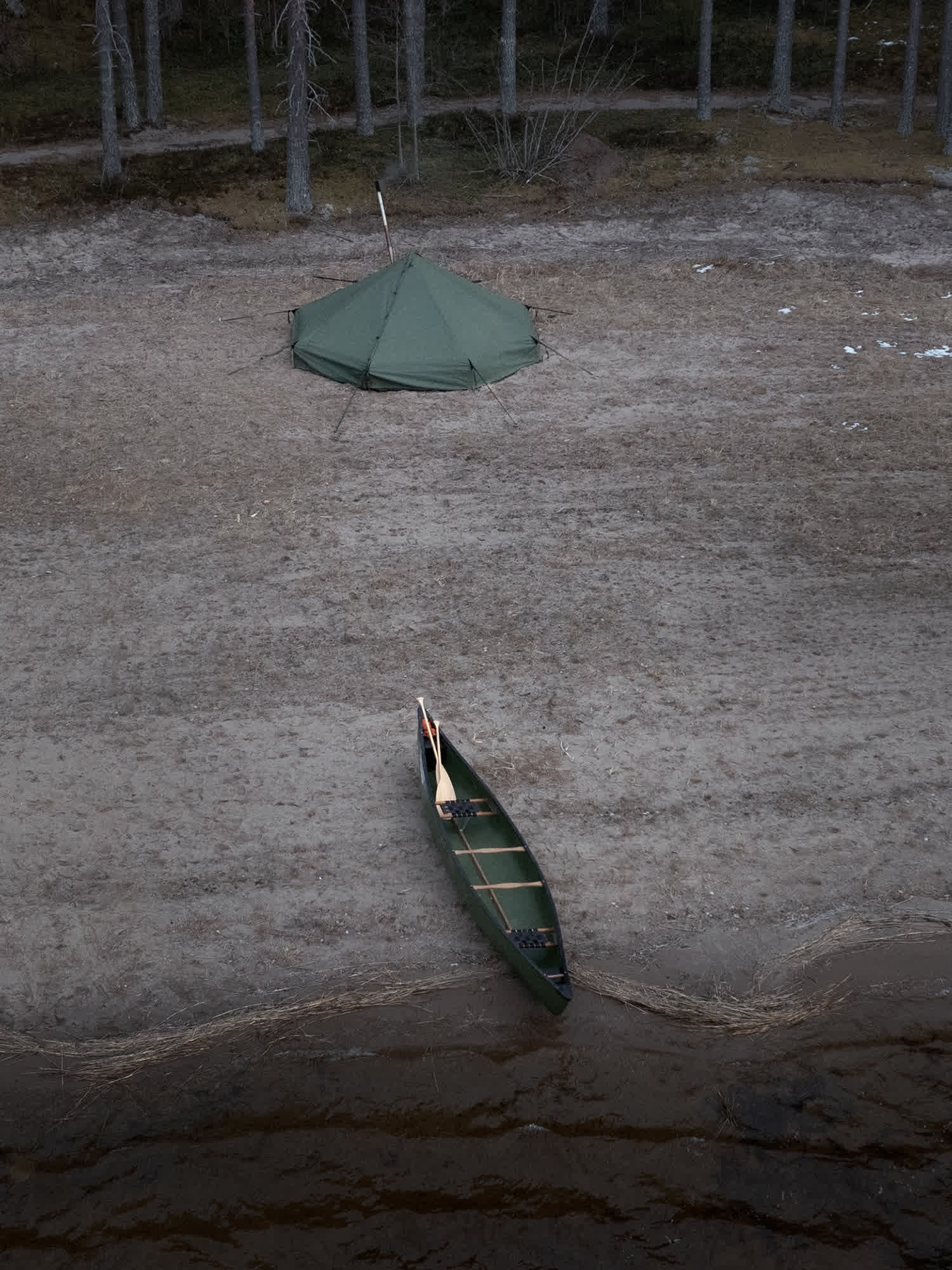 Canoe on a beach with Savotta Hawu 8 tent in the background
