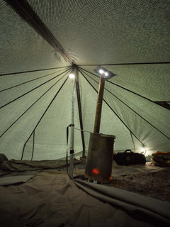 Savotta Hawu 8 tent interior with a portable stove and lighting setup