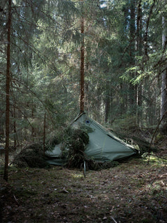 Savotta Hawu 8 tent set up in a dense forest