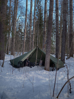 Savotta Hawu 8 tent set up in a snowy forest