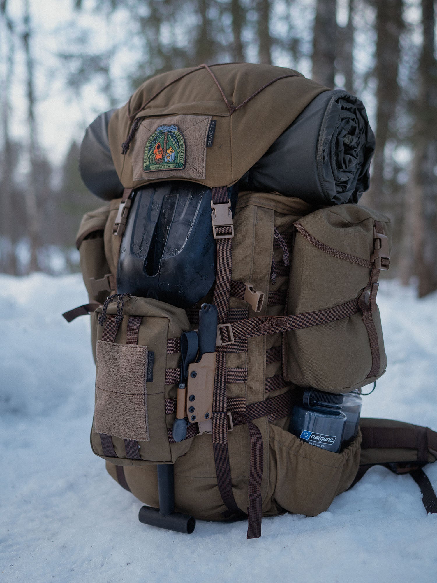 Brown Savotta Kantamus backpack with camping gear in a snowy forest