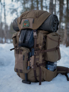 Brown Savotta Kantamus backpack with camping gear in a snowy forest