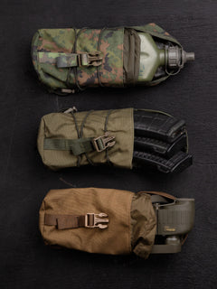 Three Savotta Lidded GP pouches 3x4 on a dark wooden surface. One containing a canteen, one holding three magazines and one with binoculars.