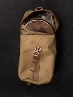 Brown Savotta lidded GP pouch 4x5 containing a metal pot on a black background