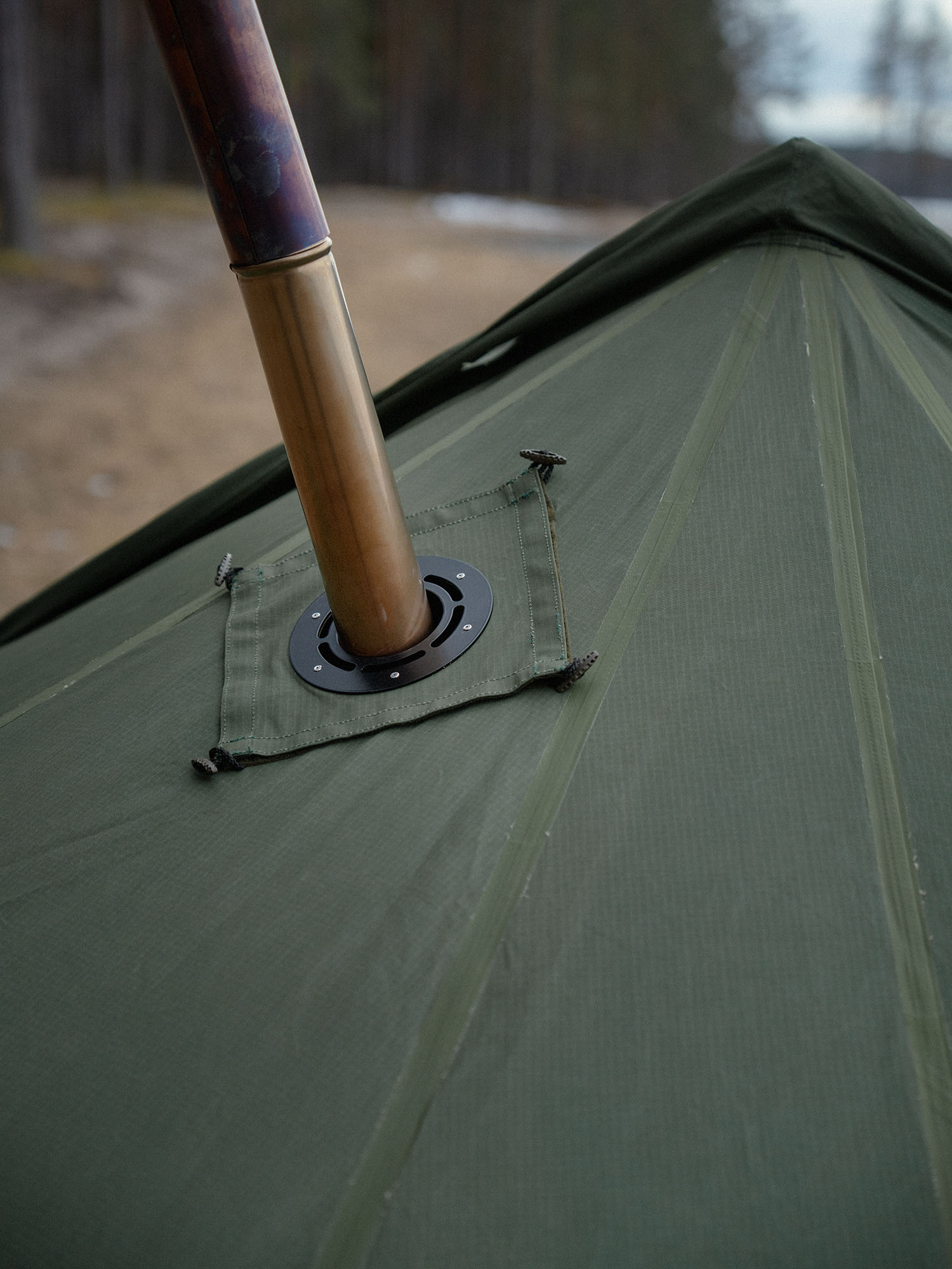 Close-up of the roof of Savotta Hawu 8 tent with the stove chimney and steel stove jack piece